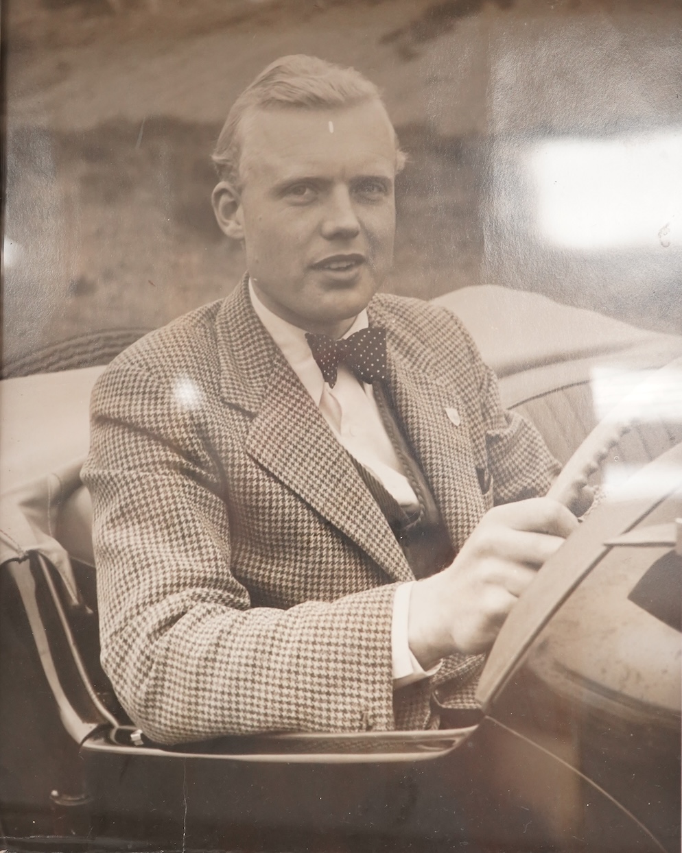 Mike Hawthorn, Challenge me the Race, signed third edition hardback book, together with a framed photograph of Mike Hawthorn, and a press photo of Mike Hawthorn and Stirling Moss (3) Condition - fair